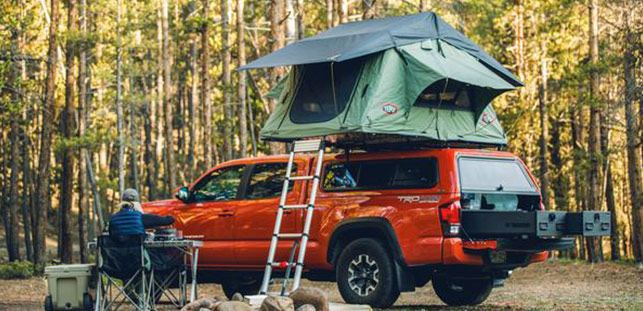 Women Cooking in Forest with Vehicle Roof Top Tent